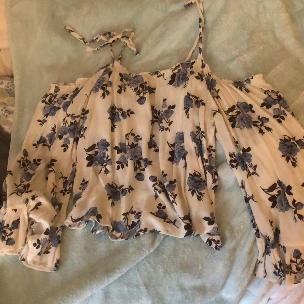White Cold-Shoulder blouse with blue flowers.